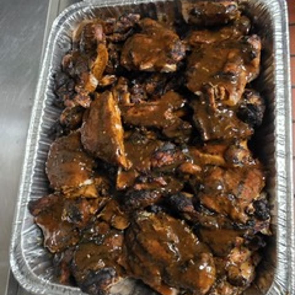 Sweet Fingers catering tray filled with sauced chicken.
