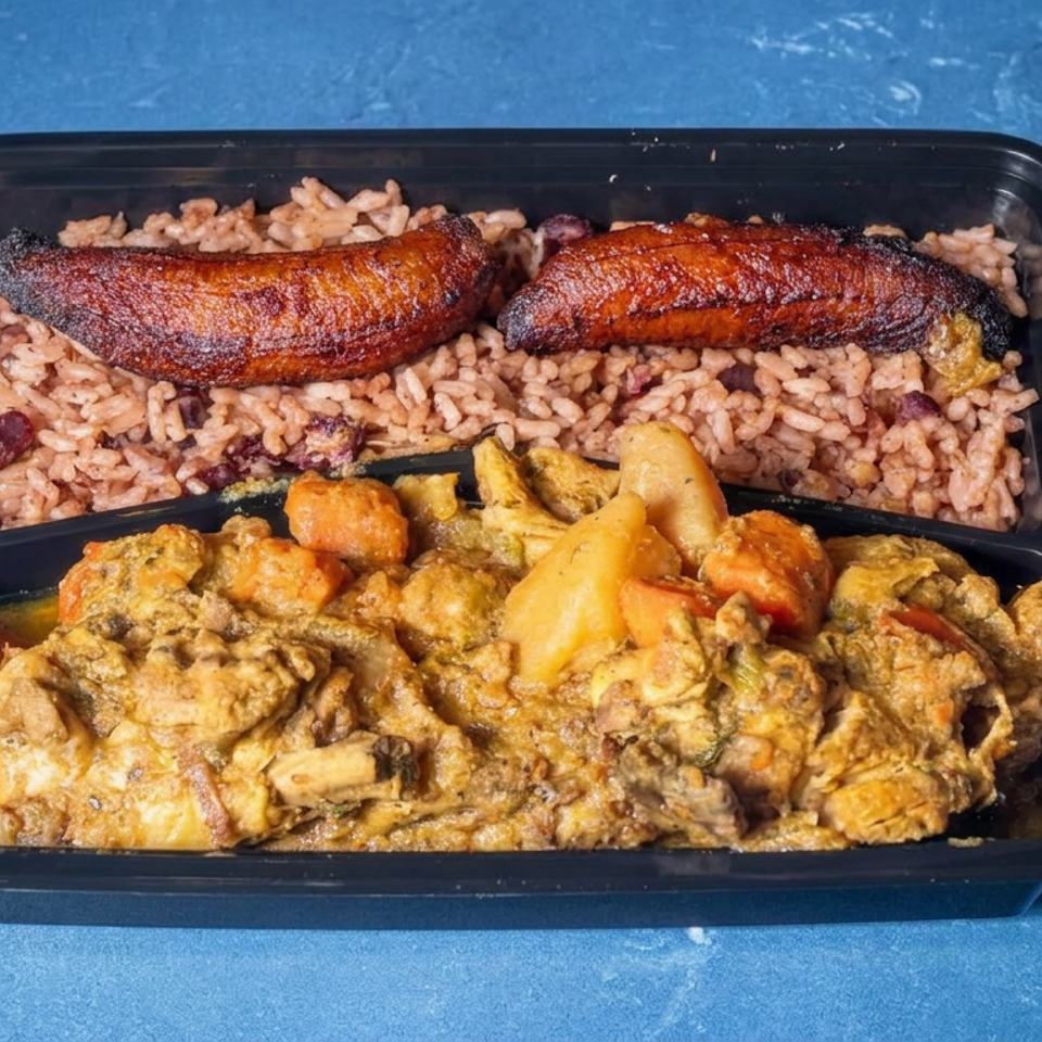 Takeout tray featuring rice and beans, fried plantains, and creamy stewed vegetables on a blue surface.