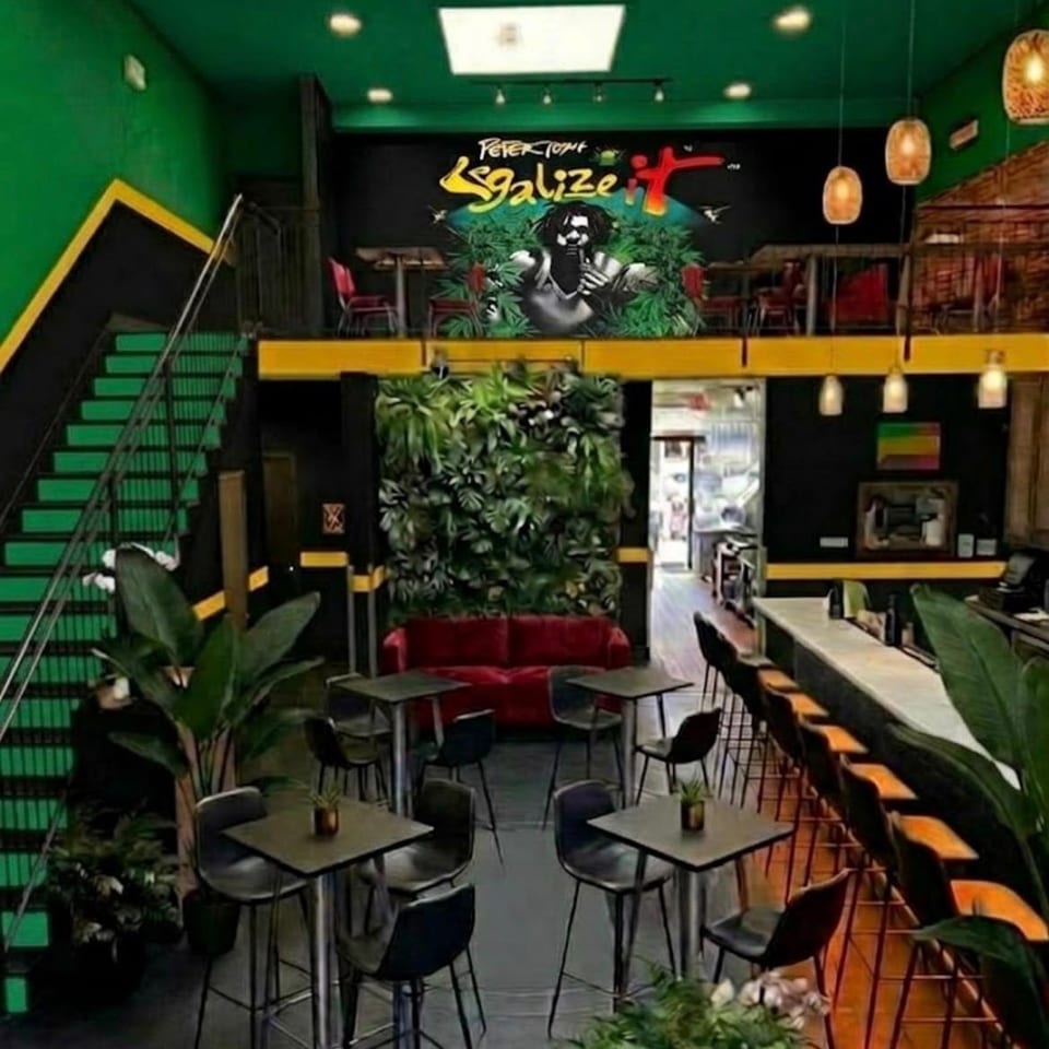 Sweet Fingers Uptown bar and mezzanine with green walls and yellow accents.